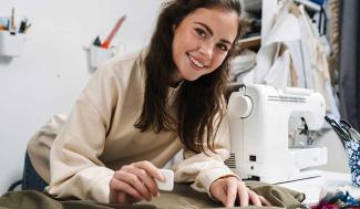 woman with fabric and sewing machine