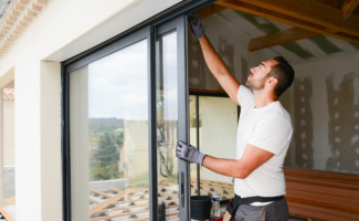 Contractor installing window on a house